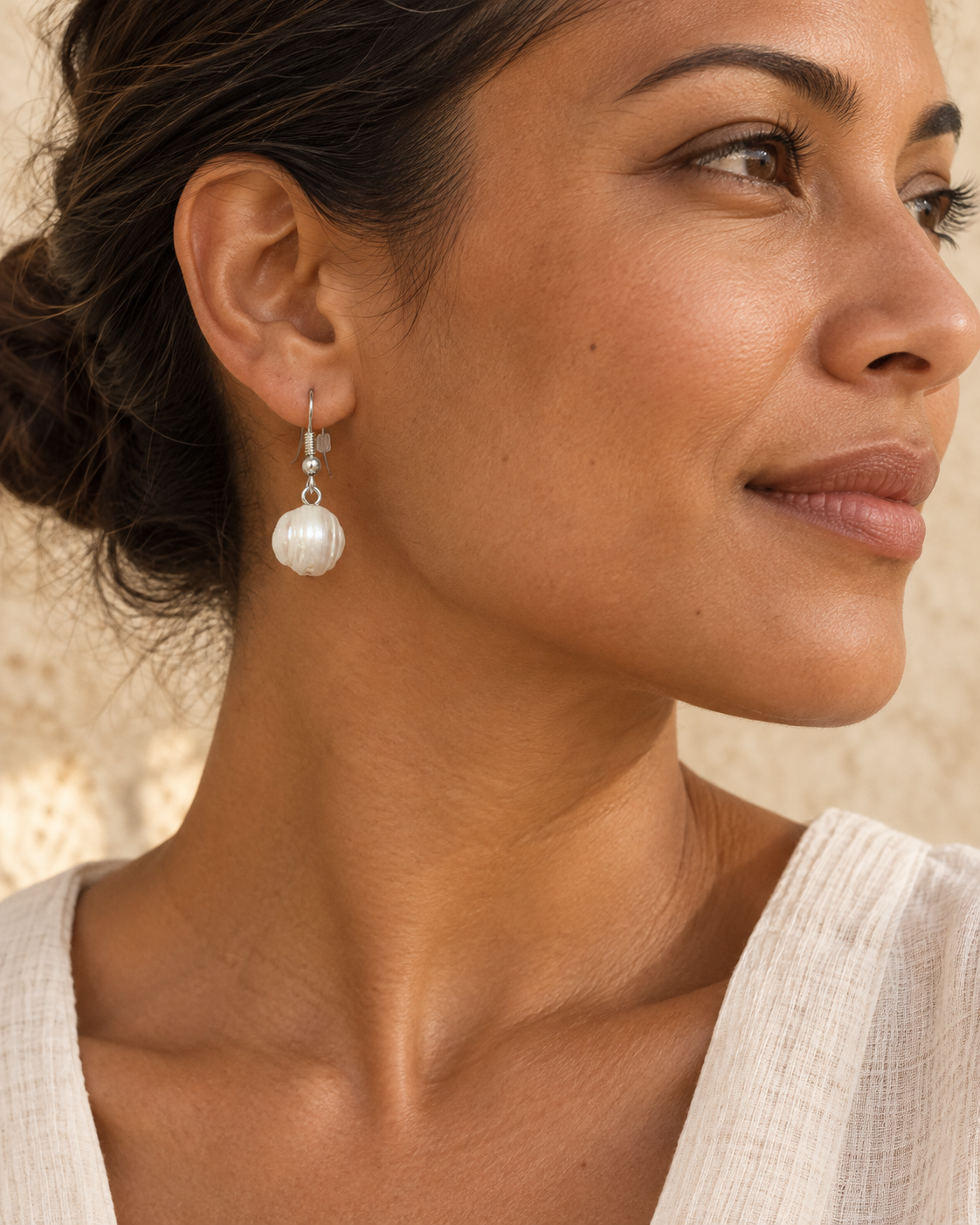 AI styling illustration of a model wearing a white baroque pearl earring