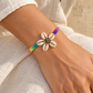 AI-generated styling illustration of Braided Rainbow Bracelet With Shells worn by a model. Refer to original product photographs for details; scale is illustrative.