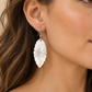 AI-generated styling illustration of Leaf-Shaped Mother of Pearl Shell Earrings worn by a model. Refer to original product photographs for details; scale is illustrative.